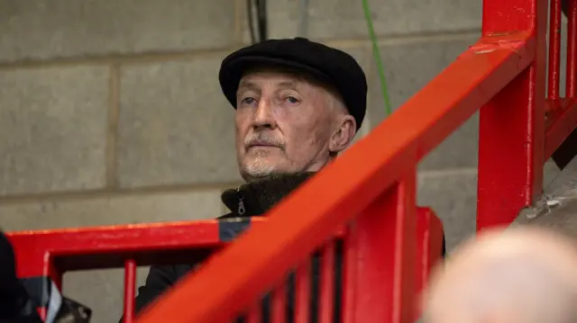 Banned Swindon boss Ian Holloway watches from the stands