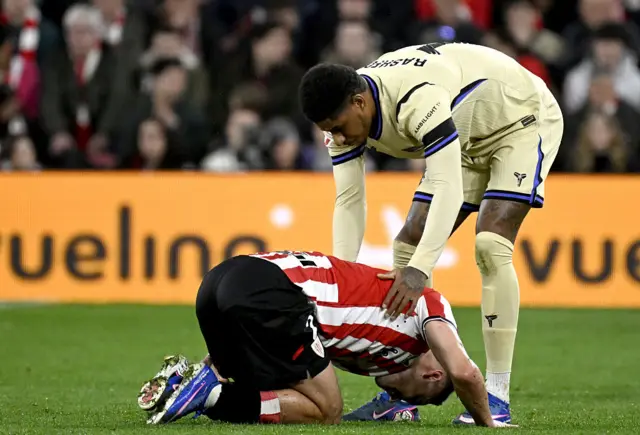 Barcelona's English forward #14 Marcus Rashford helps Athletic Bilbao's Spanish defender #02 Andoni Gorosabel