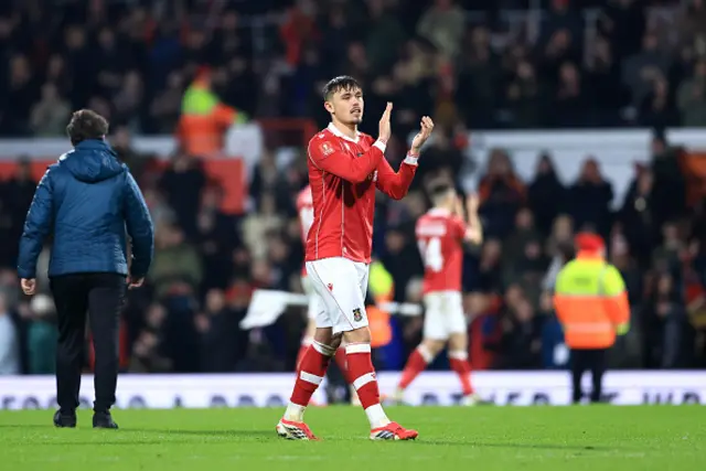 Callum Doyle of Wrexham applauds the fans