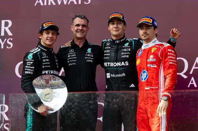 George Russell, Andrea Kimi Antonelli, Charles Leclerc and a Mercedes team member on the podium