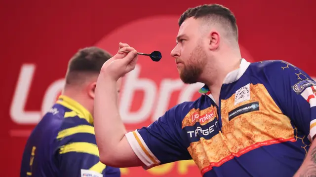 Josh Rock throws a dart
