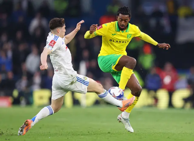 Paris Maghoma is challenged by Daniel James