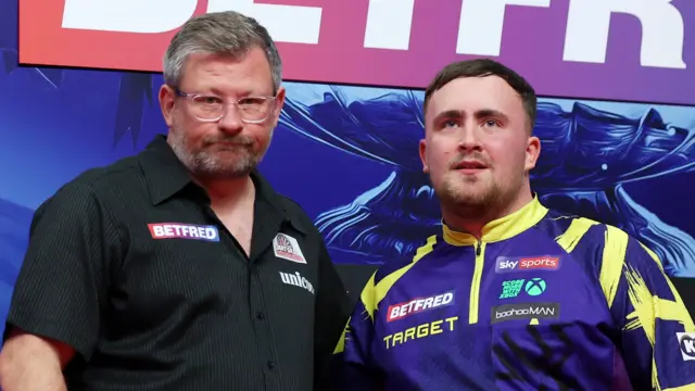 James Wade and Luke Littler stand together after the World Matchplay final