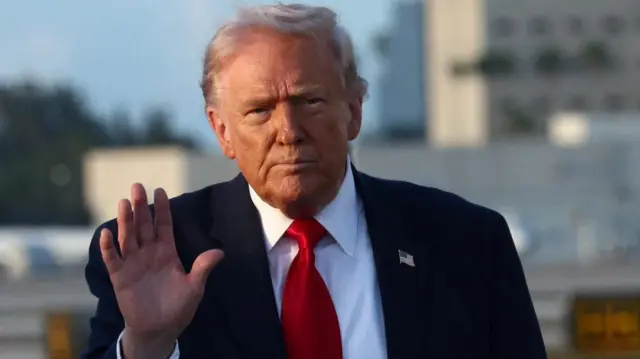 Donald Trump waves his right hand