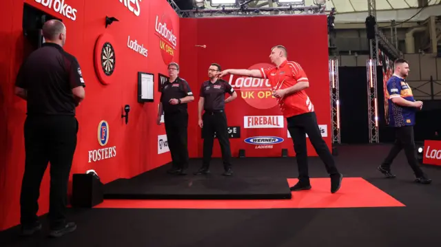 Krzysztof Ratajski throws a dart