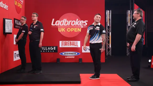 Gerwyn Price reacts after miscounting his score