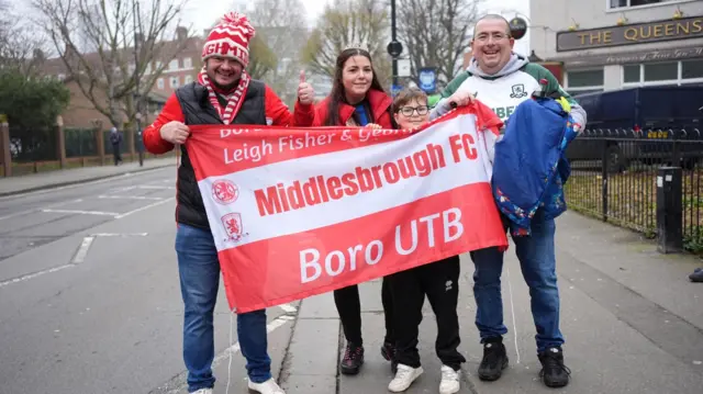Middlesbrough fans hold up a banner outside Loftus Road