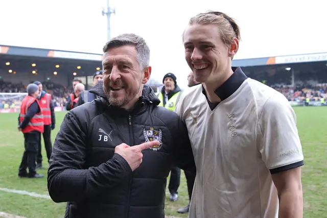 Jon Brady, head coach of Port Vale, celebrates with goalscorer Ben Waine