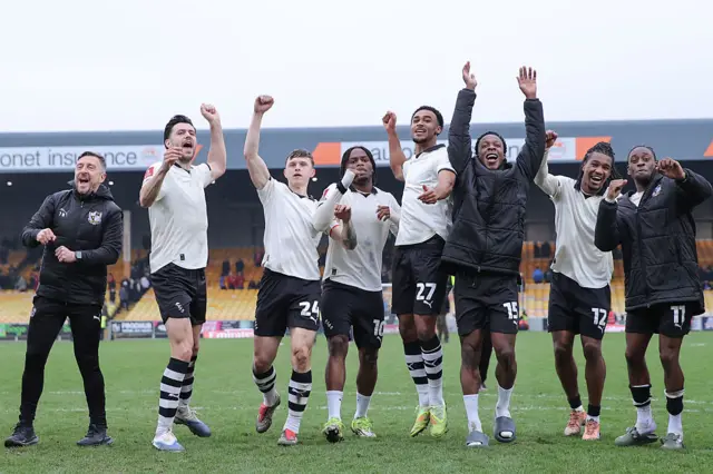 Players and staff of Port Vale celebrate victory