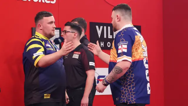 Luke Littler and Josh Rock shake hands