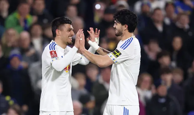 Joel Piroe of Leeds United celebrates scoring his team's third goal with teammate Pascal Struijk