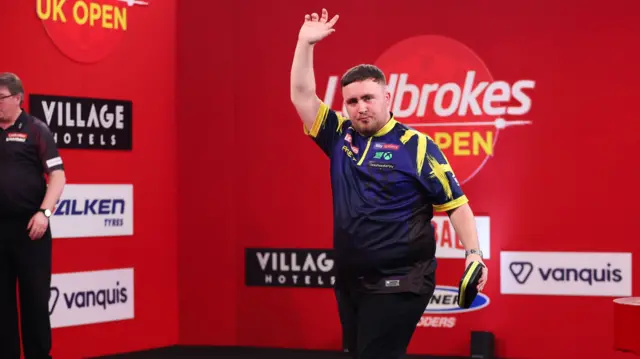 Luke Littler waves to the crowd