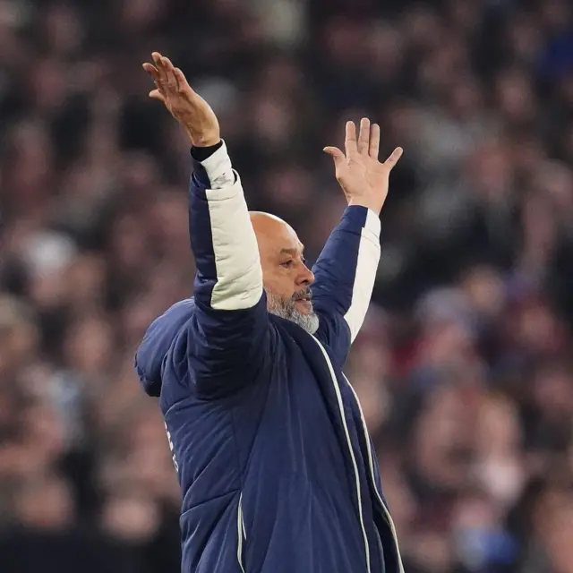 Nuno throws his arms in the air