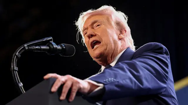 Donald Trump speaks at a podium