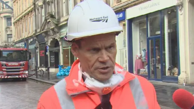 Ross Moran, route director at Network Rail Scotland with a fire engine in the background