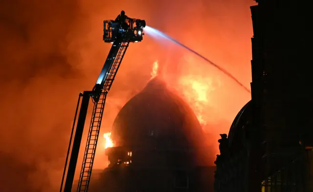 a burning building tackled by firefighters
