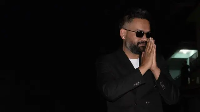 Balendrah Shah with his palms together