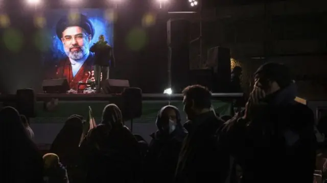 A picture of Iran's new supreme leader, Mojtaba Khamenei, displayed on a screen in Tehran last night