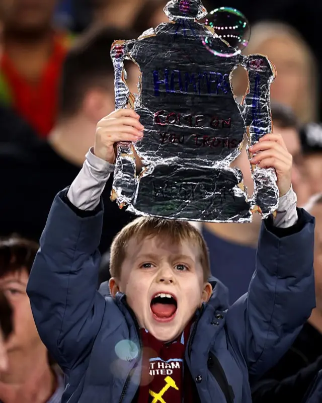 Young fan holds u a tinfoil FA Cup