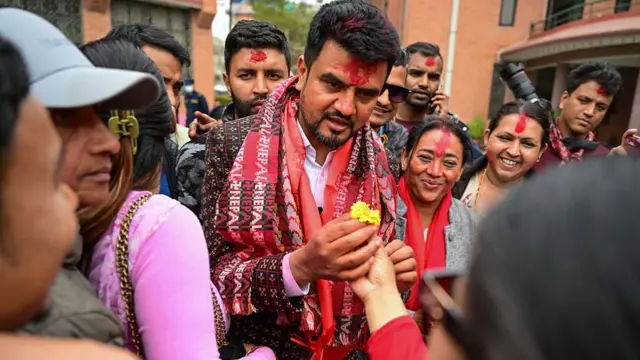 Rajiv Khatri receives a flower from a party worker after winning his seat on 7 March in Kathmandu