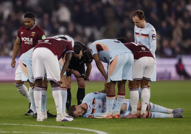 Henderson lies in pain on the floor after a rough landing