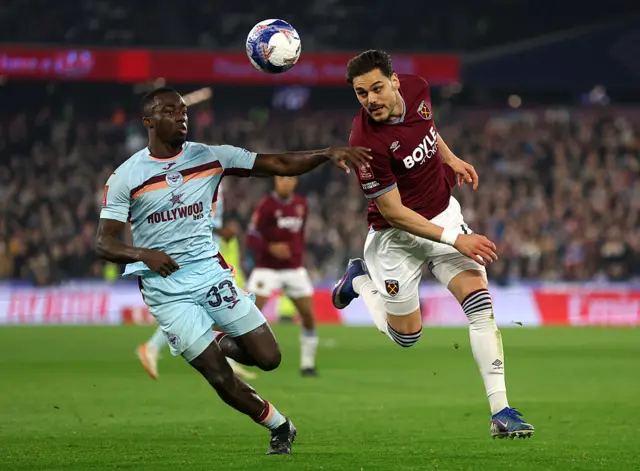 Kayode and Mavropanos duel for the ball