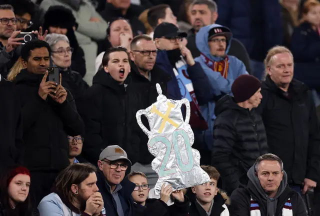 West Ham fans hold up a tinfoil trophy