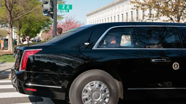 Trump sitting in the backseat of the presidential vehicle