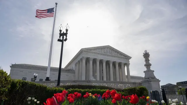 Supreme Court in the background with red, pink and purple flowers in the foreground