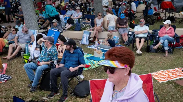 People watch on from Space View Park near the Kennedy Space Center ahead of the expected launch