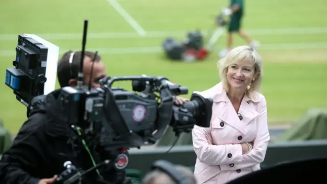 Carol Kirkwood stands in front of a camera during Wimbledon
