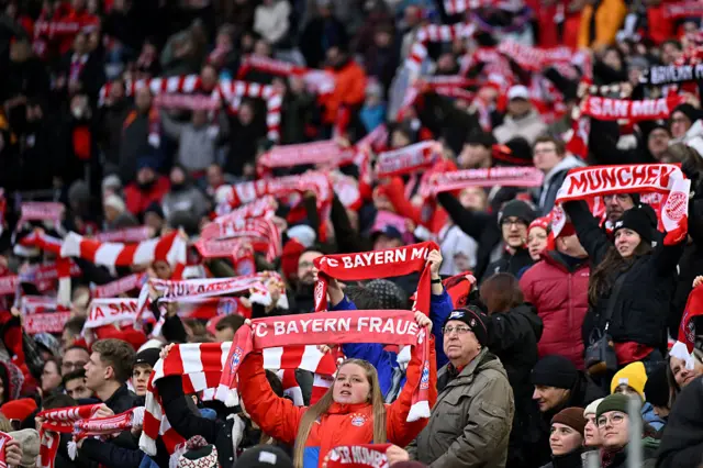Fans wave scarves for the club anthem before kick off