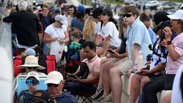 People gather to watch the launch of Artemis II from the A. Max Brewer Bridge in Titusville, Florida