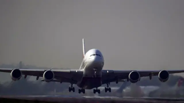 A passenger jet taking off from a runway.