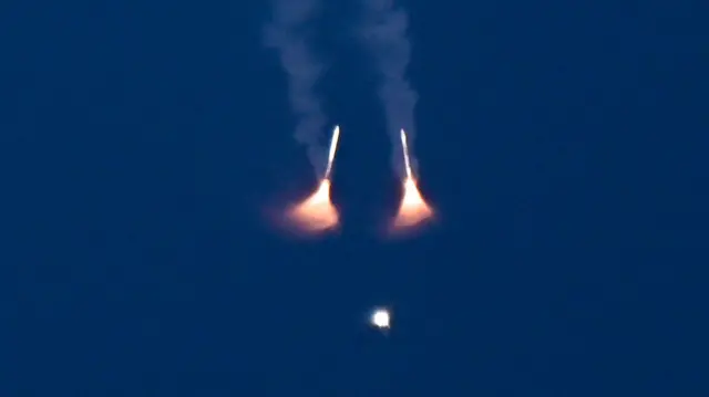 The Space Launch System (SLS) rocket carrying NASA's Artemis II Orion crew capsule ascends after liftoff, with its solid rocket boosters already detached, from the Kennedy Space Center in Cape Canaveral, Florida, U.S., April 1, 2026.