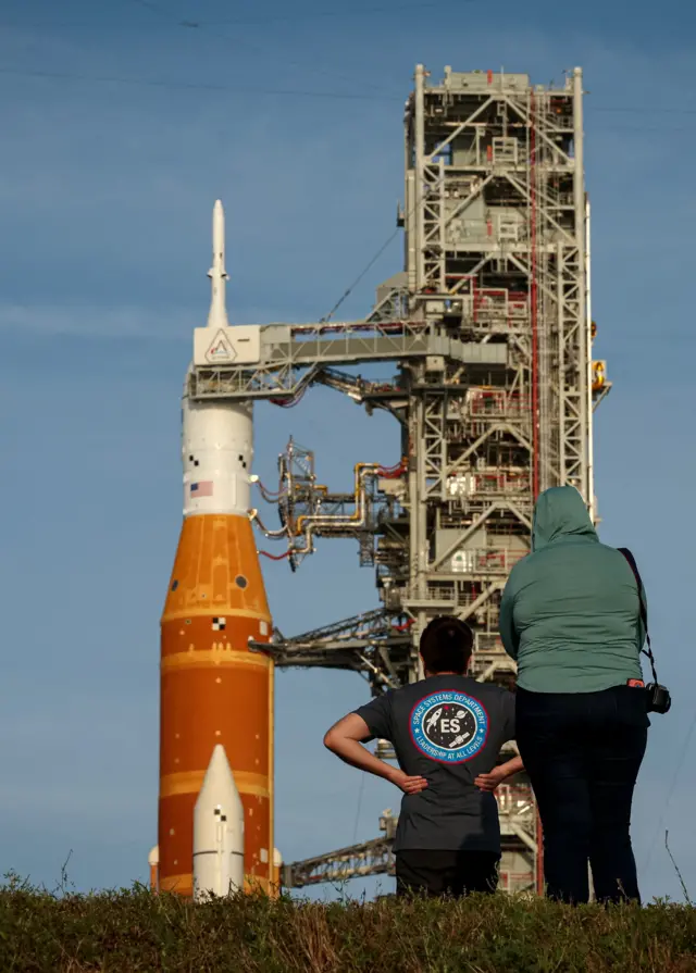 People look at NASA's Artemis II lunar flyby mission