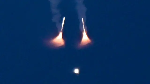 Capsule ascends after liftoff, with its solid rocket boosters already detached