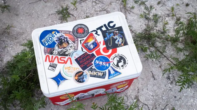 Space-related stickers on a coolbox ahead of the launch