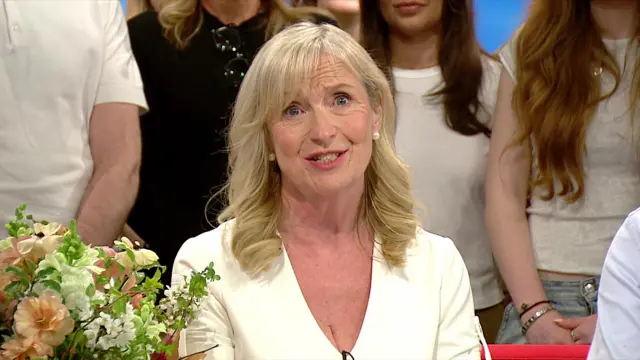 Carol sitting on a sofa