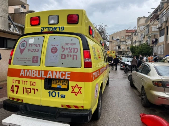 A MDA yellow ambulance parked in between cars on a street in Israel struck in a wave of Iranian attacks