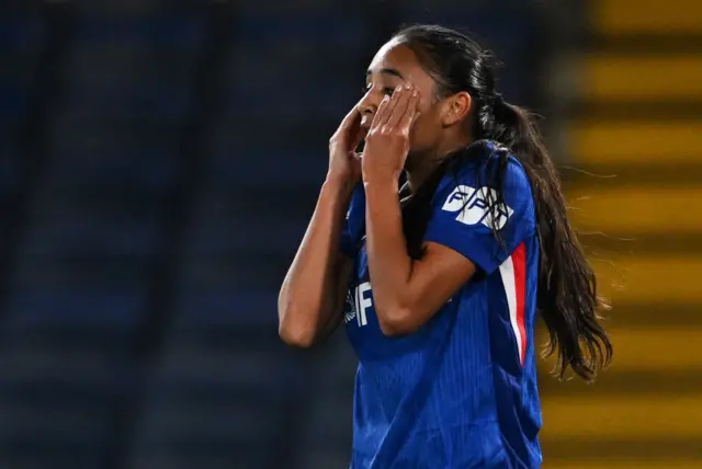 Thompson bemoans a miss as she puts her hands to her face