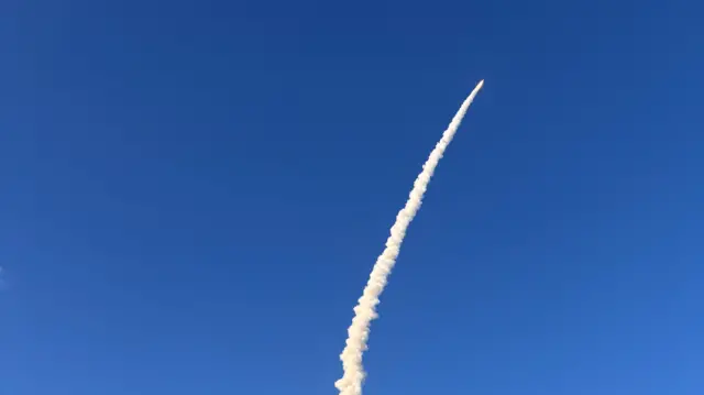 Rocket takes off into the sky with huge trail behind it