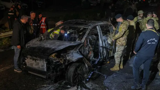 Emergency personnel operate around a burned car following a targeted Israeli strike, amid escalating hostilities between Israel and Hezbollah, as the U.S.-Israel conflict with Iran continues, in Khaldeh, Lebanon, March 31, 2026.