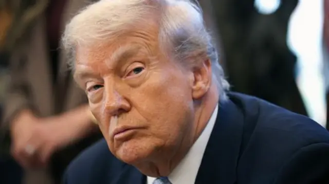 US President Donald Trump looking to the side.