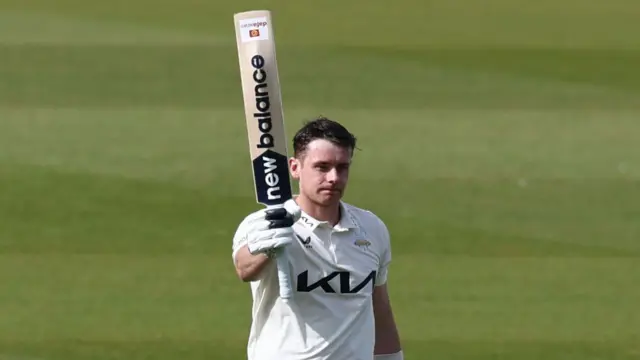 Jamie Smith with his bat raised for Surrey after scoring a century