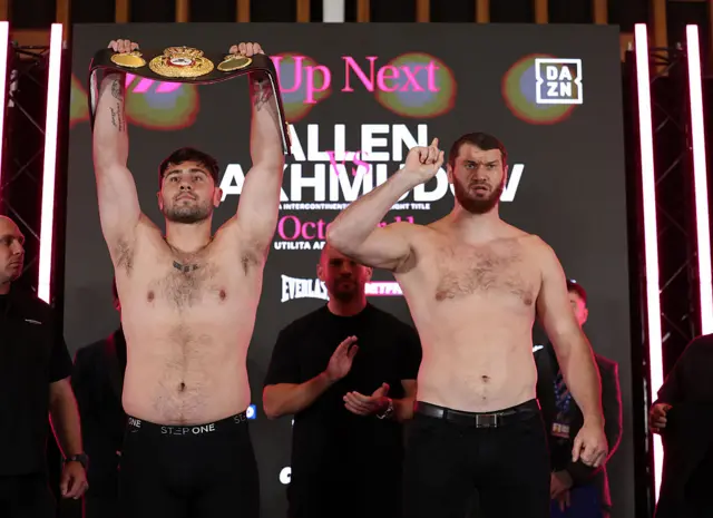 Dave Allen holds up the WBA Inter-Continental heavyweight title and stands next to Arslanbek Makhmudov