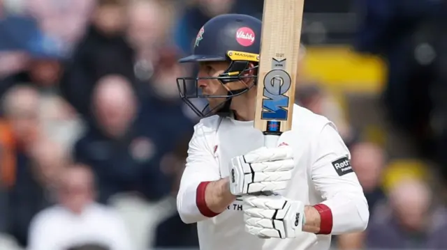 Josh Bohannon with bat raised after a shot for Lancashire