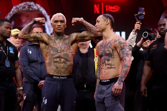 Conor Benn flexes beside Regis Prograis at a weigh-in