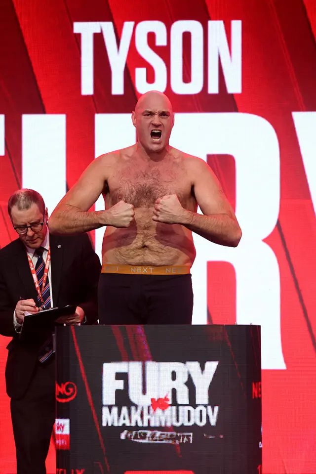 Tyson Fury weighs in and flexes his muscles