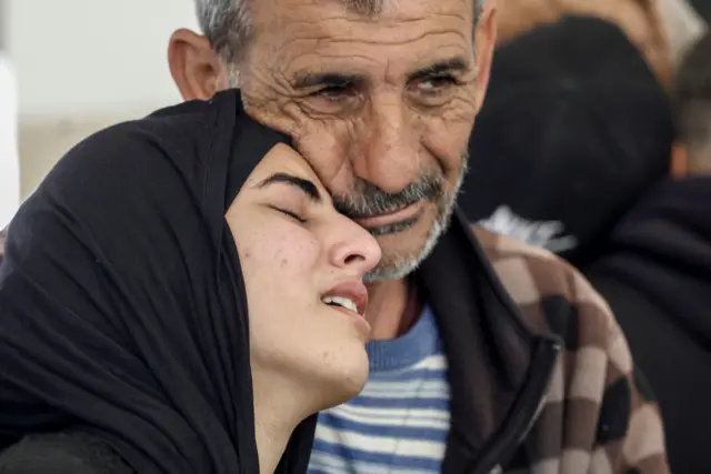 A man and a woman embrace during a funeral for six women and a man killed in sourthern Lebanon on Thursday, taken in Tyre on Friday.